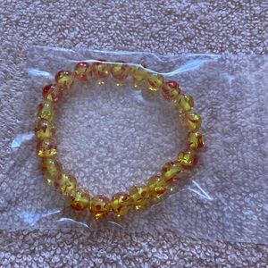 Bracelet with the colors of yellow and orange. Never been worn.
